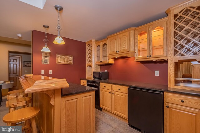kitchen with light tile patterned flooring, a breakfast bar area, decorative light fixtures, glass insert cabinets, and black appliances
