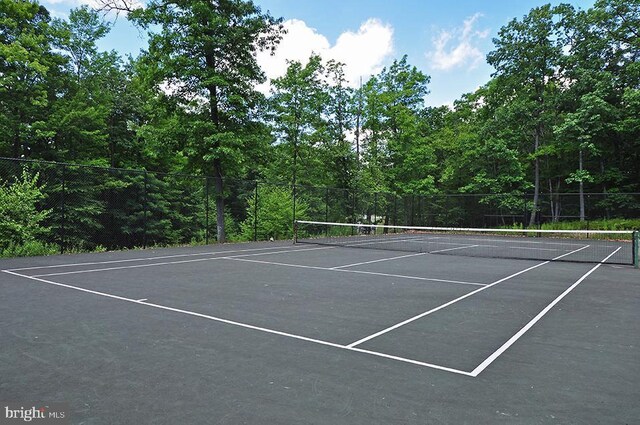 view of sport court featuring fence
