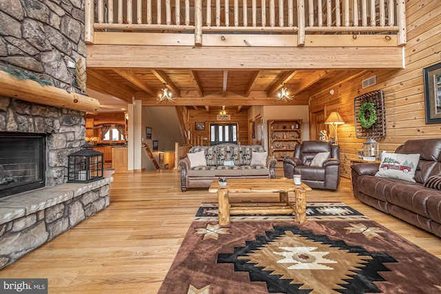 living room with beamed ceiling, visible vents, wood ceiling, and hardwood / wood-style floors