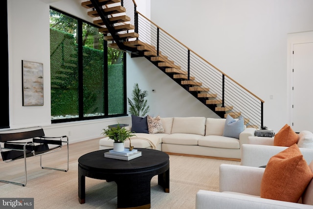 living room with stairs and wood finished floors