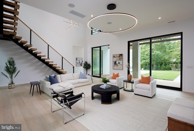 living area featuring stairway, recessed lighting, wood finished floors, and visible vents