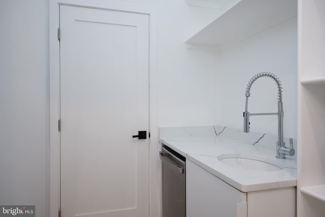 clothes washing area with a sink