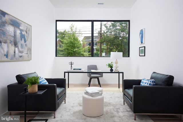 home office featuring wood finished floors and visible vents