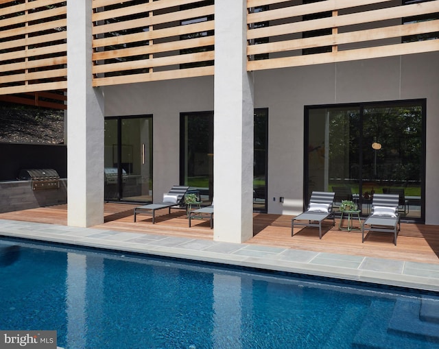 pool featuring a patio and exterior kitchen