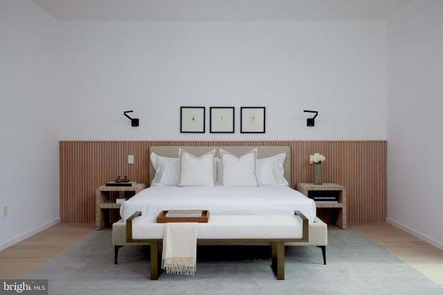 bedroom featuring baseboards and light wood finished floors