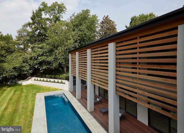 view of swimming pool featuring a lawn and a fenced in pool