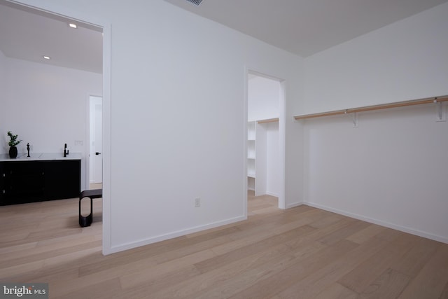 unfurnished bedroom featuring baseboards, recessed lighting, and light wood-style flooring
