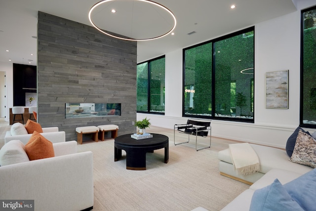 living room with a multi sided fireplace and recessed lighting