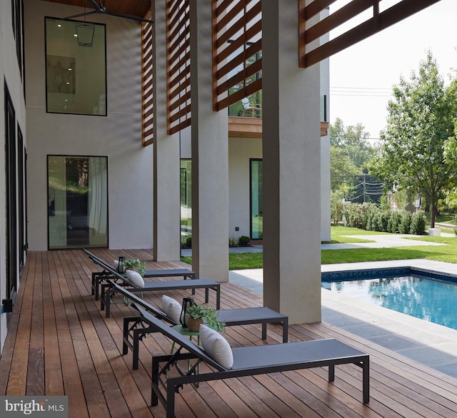 deck featuring an outdoor pool