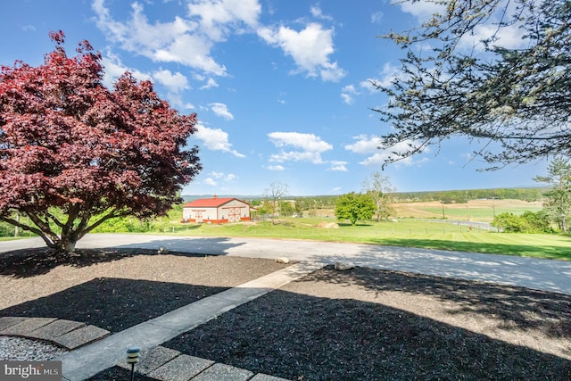 view of yard featuring a rural view and fence