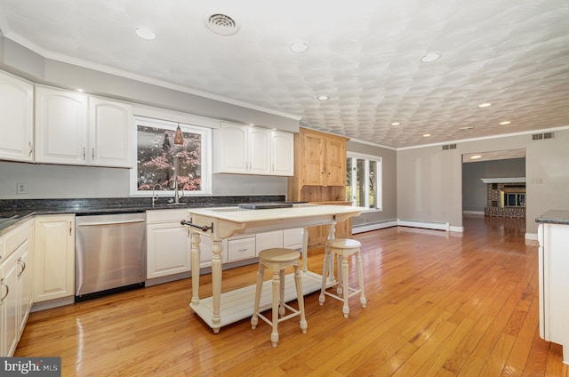 kitchen featuring ornamental molding, visible vents, recessed lighting, dishwasher, and white cabinets