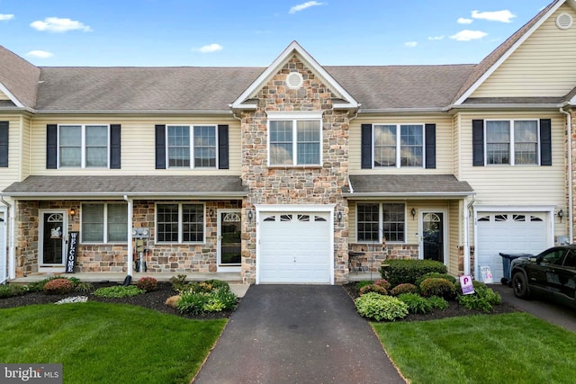 9 Ryan Ct, Telford, PA 18969 - view of front of house with aphalt driveway, a garage, stone siding, and a front yard