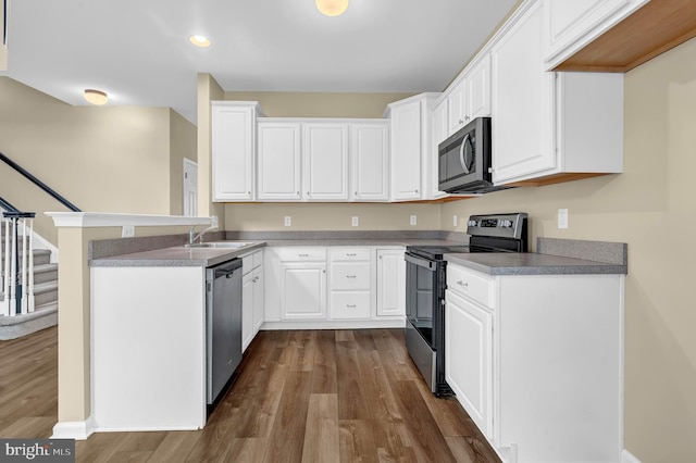 9 Ryan Ct, Telford, PA 18969 - kitchen with white cabinets, a peninsula, stainless steel appliances, and dark wood-style flooring