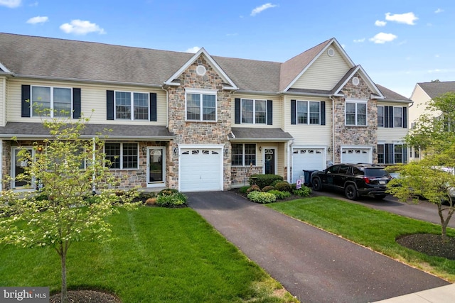 9 Ryan Ct, Telford, PA 18969 - townhome / multi-family property with a garage, a front lawn, stone siding, and driveway