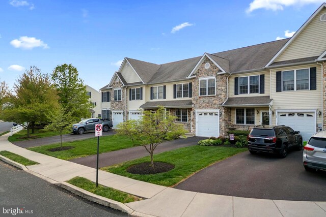 9 Ryan Ct, Telford, PA 18969 - multi unit property with driveway, stone siding, a garage, and a front yard