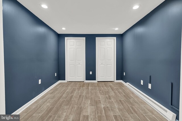 9 Ryan Ct, Telford, PA 18969 - unfurnished bedroom featuring recessed lighting, a baseboard heating unit, baseboards, multiple closets, and light wood-type flooring