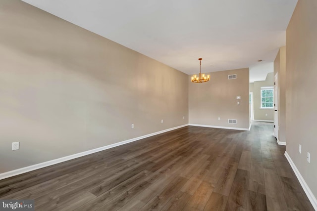 9 Ryan Ct, Telford, PA 18969 - empty room featuring baseboards, a notable chandelier, visible vents, and dark wood-type flooring