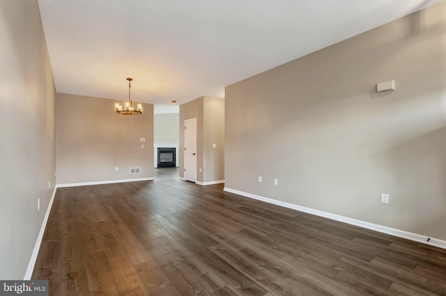 9 Ryan Ct, Telford, PA 18969 - unfurnished living room with dark wood finished floors, visible vents, baseboards, and a notable chandelier