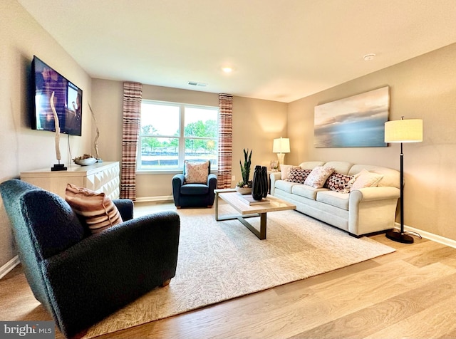 living area featuring recessed lighting, baseboards, visible vents, and wood finished floors