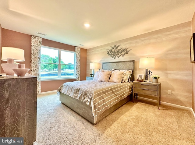 bedroom featuring baseboards, visible vents, and carpet