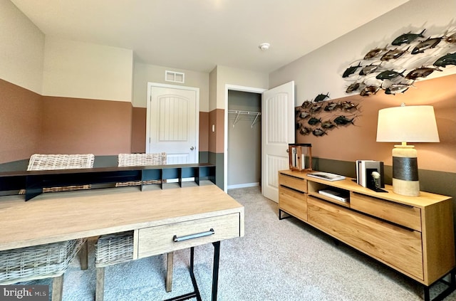 office featuring visible vents, baseboards, and light carpet