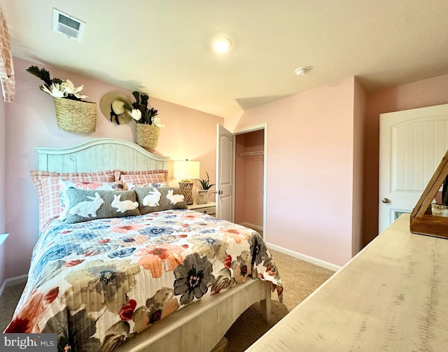 carpeted bedroom with visible vents, baseboards, and a closet