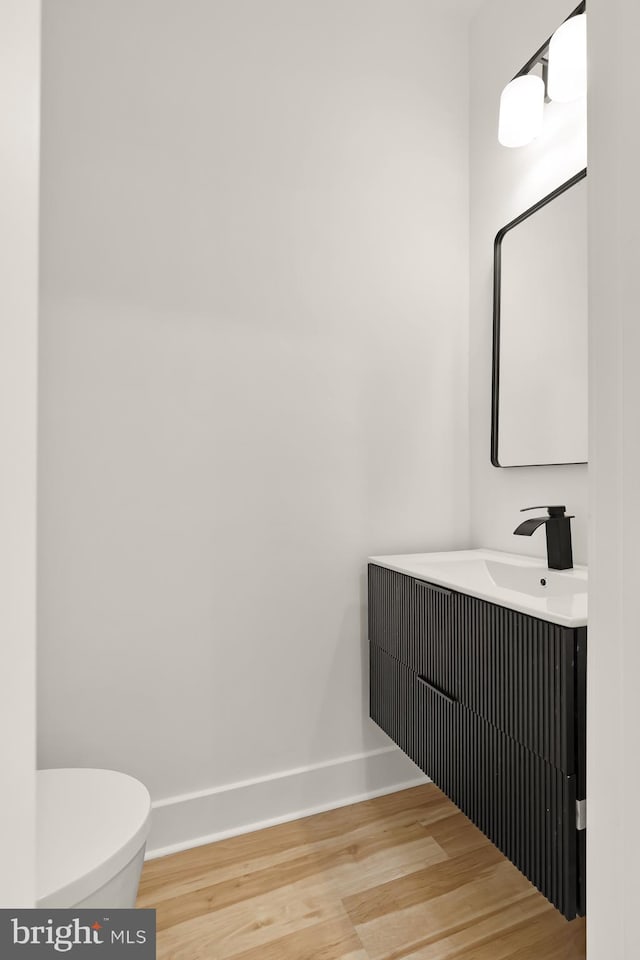 1251 Morse St NE Unit Ph3, Washington, DC 20002 - half bath with toilet, baseboards, wood finished floors, and vanity