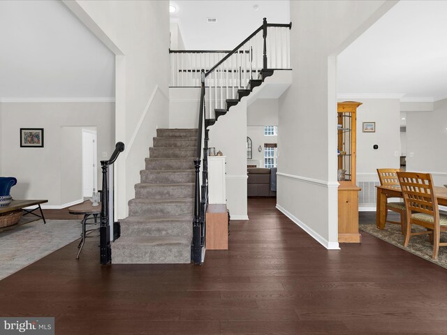 8283 Waterford Mill Ct, Pasadena, MD 21122 - foyer featuring ornamental molding, wood finished floors, baseboards, a high ceiling, and stairway