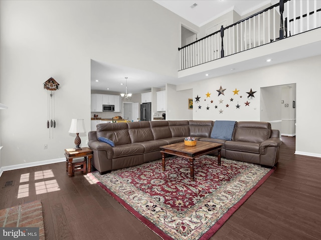 8283 Waterford Mill Ct, Pasadena, MD 21122 - living area with dark wood-style flooring, a high ceiling, a chandelier, and baseboards