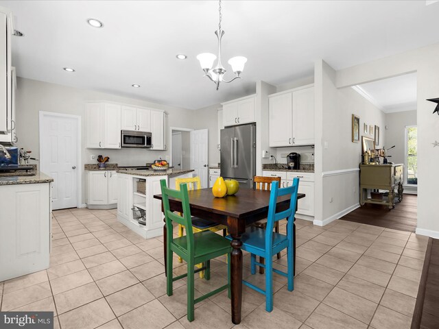 8283 Waterford Mill Ct, Pasadena, MD 21122 - dining space with crown molding, baseboards, recessed lighting, light tile patterned floors, and a notable chandelier