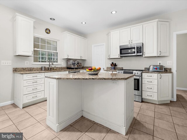 8283 Waterford Mill Ct, Pasadena, MD 21122 - kitchen featuring a sink, appliances with stainless steel finishes, light stone countertops, and white cabinetry
