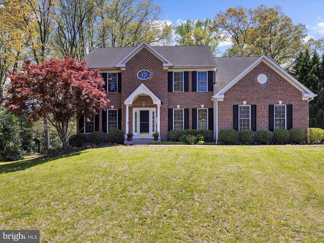 8283 Waterford Mill Ct, Pasadena, MD 21122 - view of front facade with brick siding, roof with shingles, and a front lawn