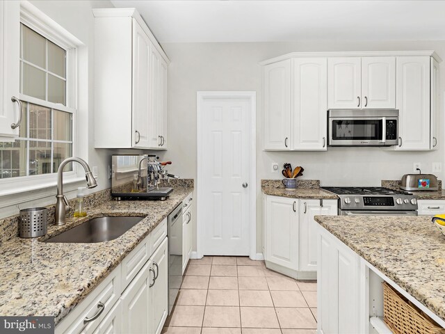 8283 Waterford Mill Ct, Pasadena, MD 21122 - kitchen with a sink, light tile patterned floors, white cabinets, and stainless steel appliances