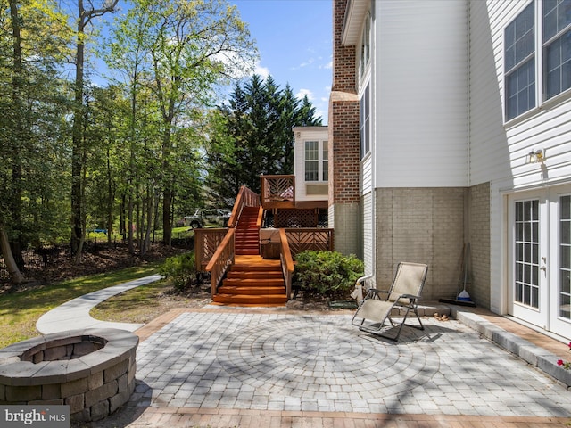 8283 Waterford Mill Ct, Pasadena, MD 21122 - view of patio / terrace with french doors, stairs, and a fire pit