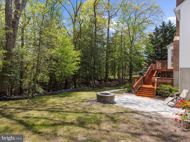 8283 Waterford Mill Ct, Pasadena, MD 21122 - view of yard with stairs, an outdoor fire pit, and a patio area