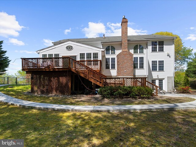 8283 Waterford Mill Ct, Pasadena, MD 21122 - rear view of house with a wooden deck, fence, a chimney, a lawn, and stairway