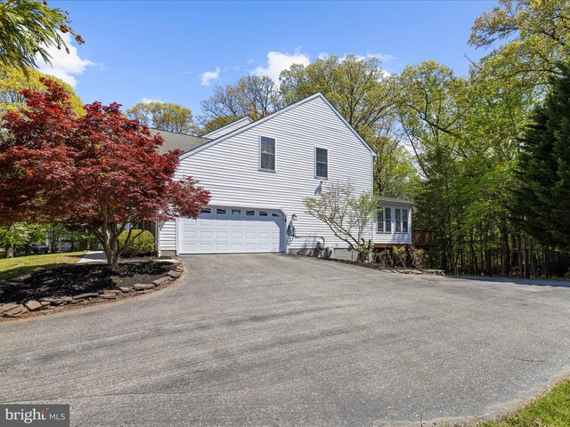 8283 Waterford Mill Ct, Pasadena, MD 21122 - view of side of home featuring a garage, a shingled roof, and aphalt driveway