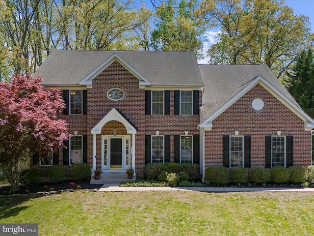 8283 Waterford Mill Ct, Pasadena, MD 21122 - colonial inspired home featuring brick siding, a shingled roof, and a front yard