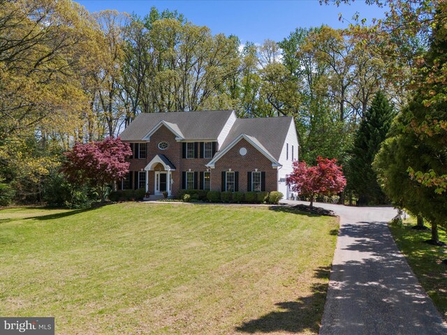 8283 Waterford Mill Ct, Pasadena, MD 21122 - colonial home featuring brick siding, aphalt driveway, and a front yard
