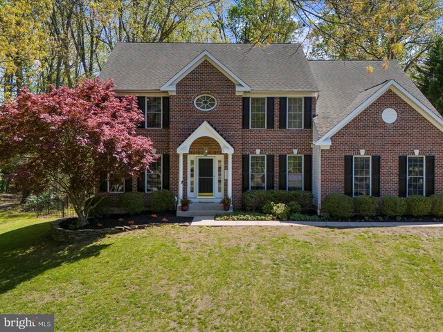 8283 Waterford Mill Ct, Pasadena, MD 21122 - view of front of property with brick siding, roof with shingles, and a front lawn
