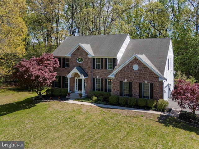 8283 Waterford Mill Ct, Pasadena, MD 21122 - colonial inspired home featuring brick siding, a front yard, and roof with shingles