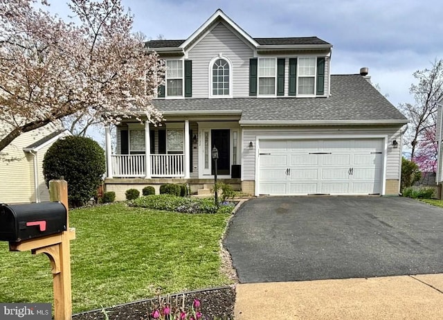 traditional-style house featuring a porch, a shingled roof, a front yard, and aphalt driveway