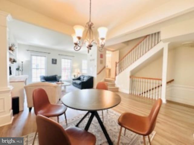 2206 Greywing St, Woodbridge, VA 22191 - dining area with wood finished floors, a chandelier, and stairway