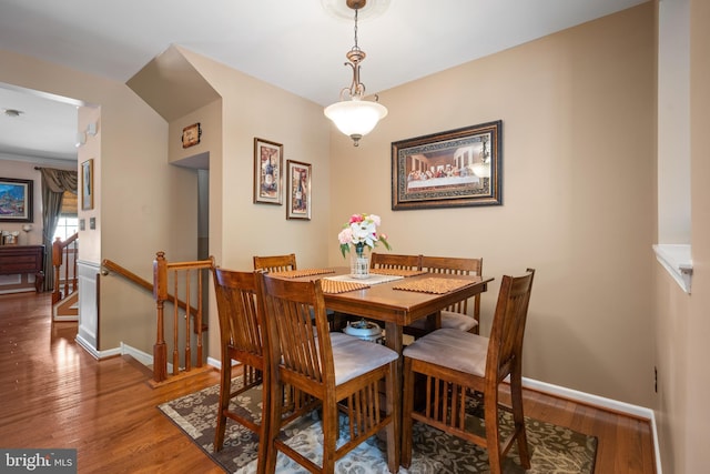 dining area featuring baseboards and wood finished floors