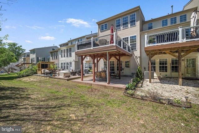 rear view of property featuring a patio area, a yard, a residential view, and cooling unit