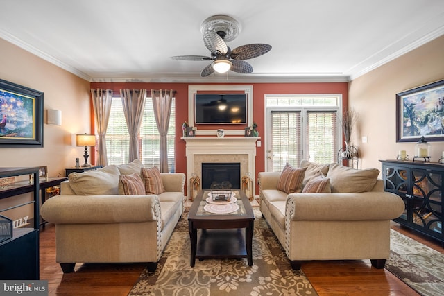 living room featuring crown molding, a ceiling fan, and a wealth of natural light