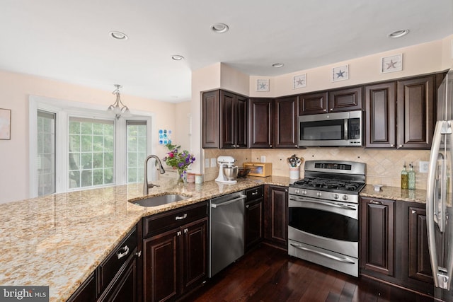 5229 Woodleaf Ct, Centreville, VA 20120 - kitchen with stainless steel appliances, a sink, dark wood-type flooring, dark brown cabinets, and backsplash