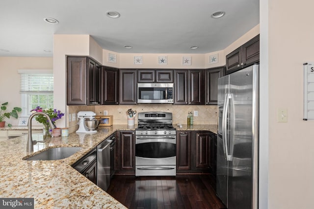 5229 Woodleaf Ct, Centreville, VA 20120 - kitchen with stainless steel appliances, a sink, dark wood-style flooring, dark brown cabinets, and light stone counters