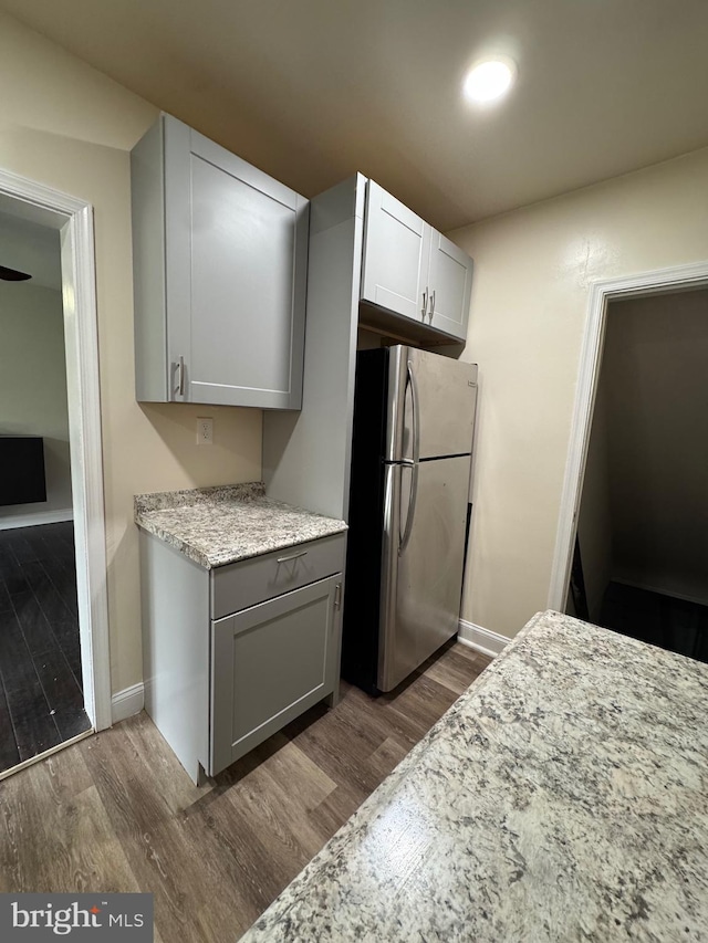 1333 E Northern Pkwy, Baltimore, MD 21239 - kitchen featuring freestanding refrigerator, dark wood-style flooring, baseboards, and light stone countertops