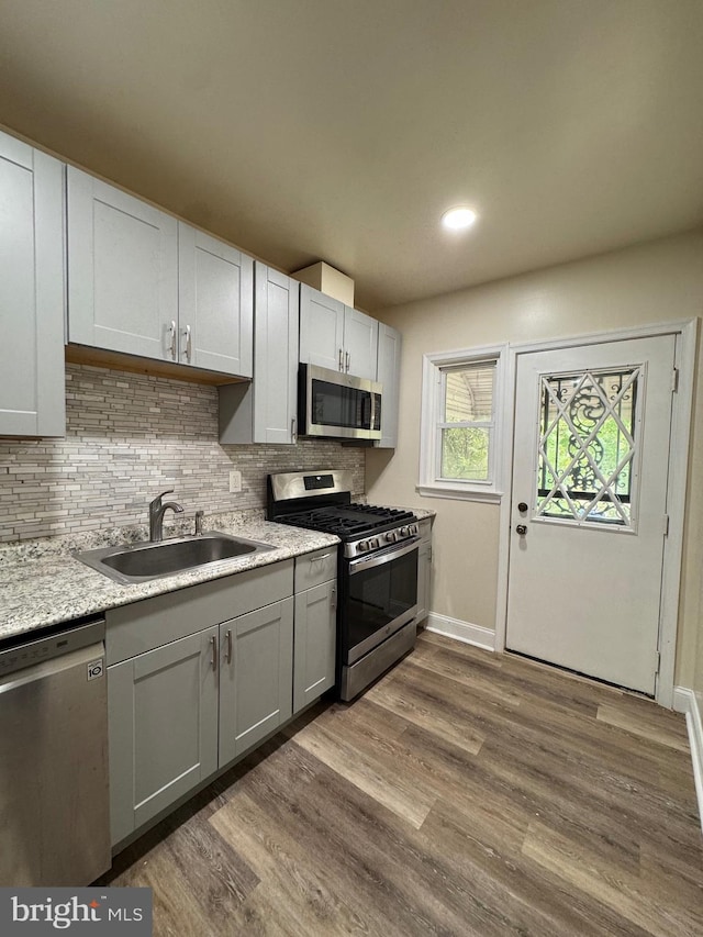 1333 E Northern Pkwy, Baltimore, MD 21239 - kitchen featuring appliances with stainless steel finishes, a sink, backsplash, dark wood-style floors, and gray cabinetry